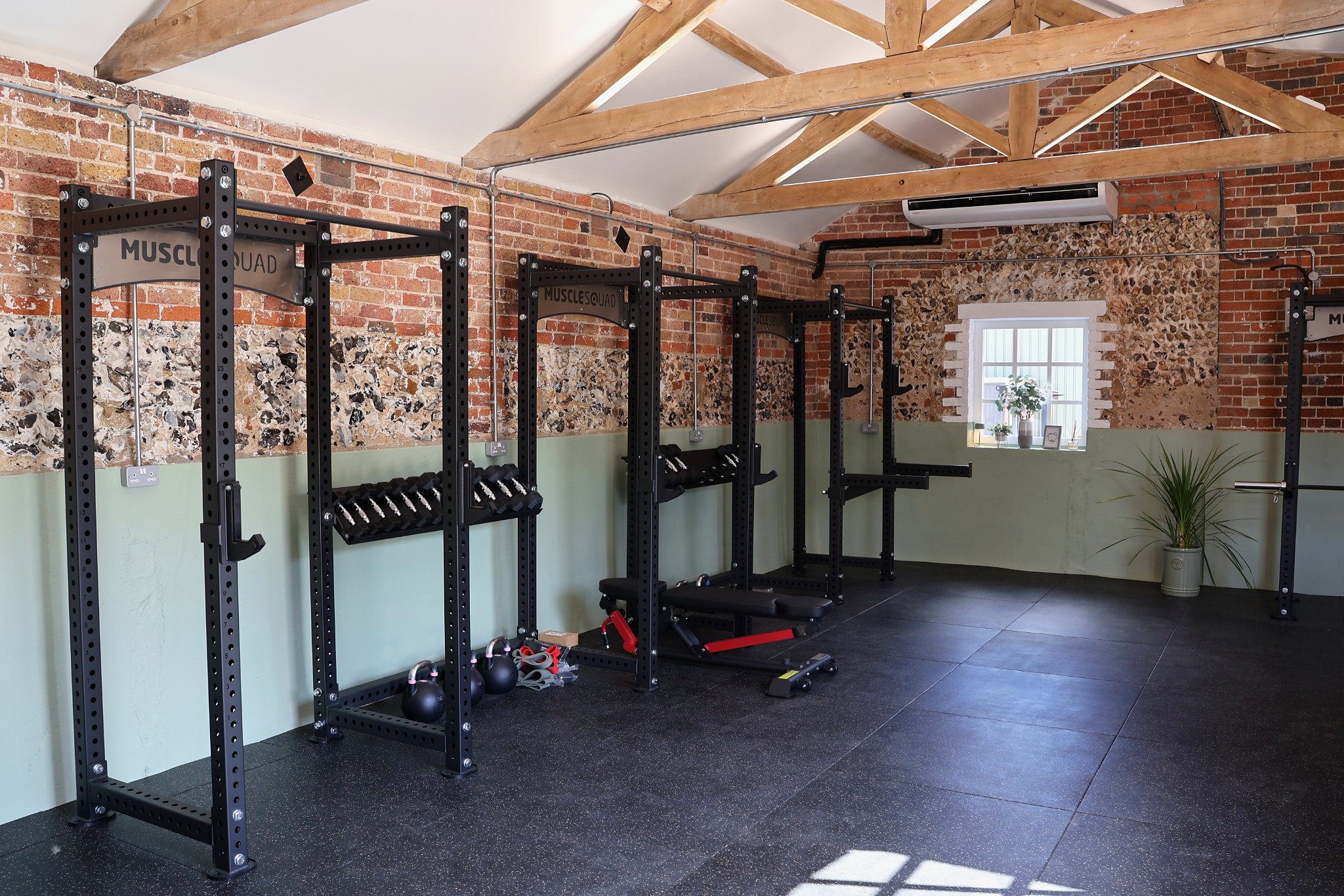 Strength training racks inside The Stable Studio at Lodge Farm